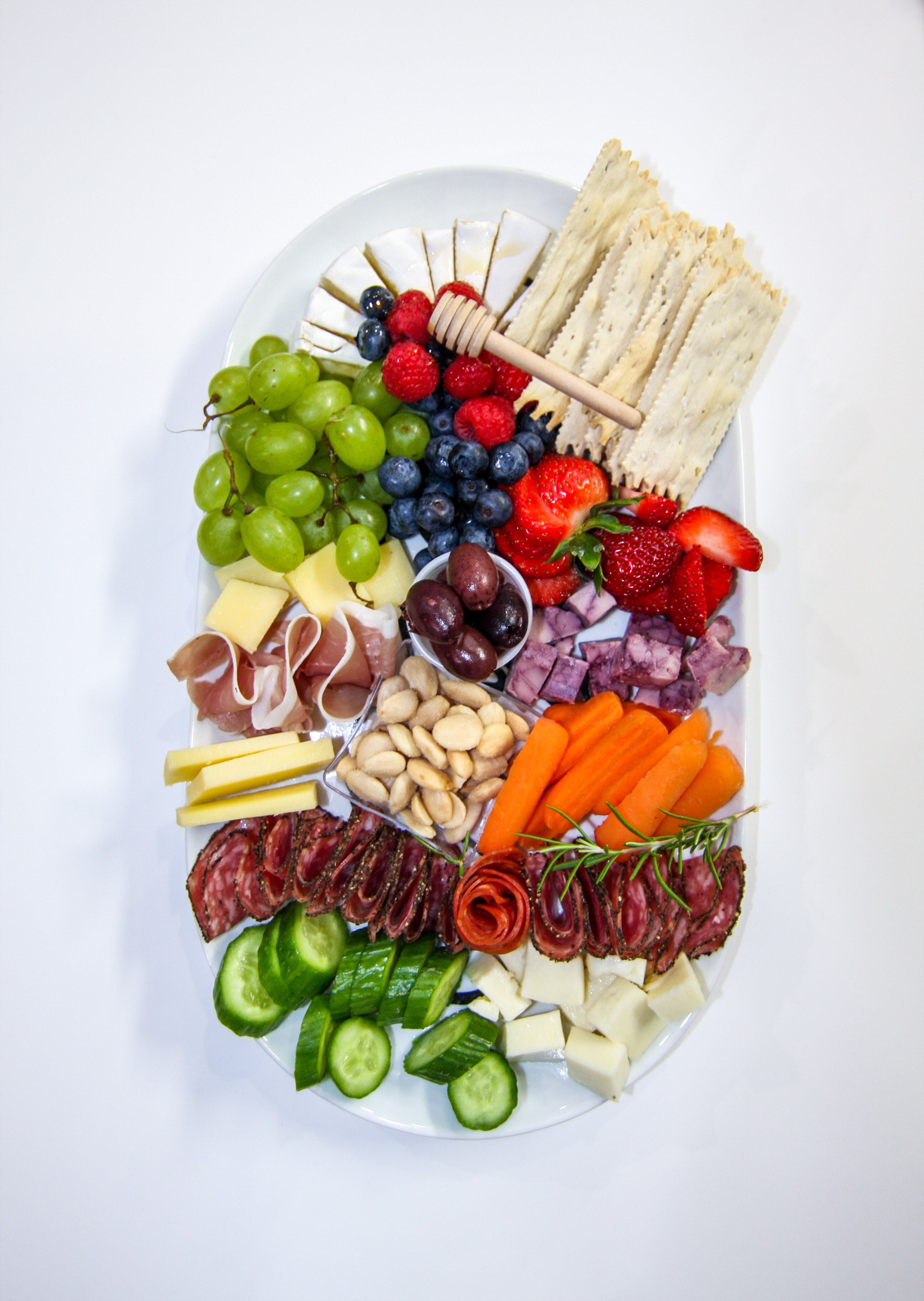 Artisanal charcuterie board with fresh fruits, meats, and cheeses